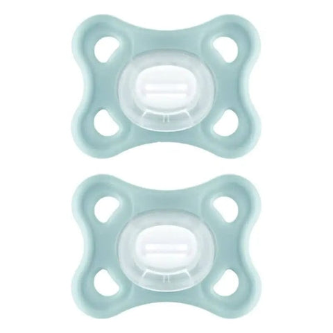 Two neutral Mam Comfort pacifiers for 3-12 months, designed for babies, by Jag Couture London New York.