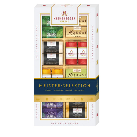 Assorted bite-sized marzipan, praline, and chocolate treats from Jag Couture London New York, arranged in a decorative box.