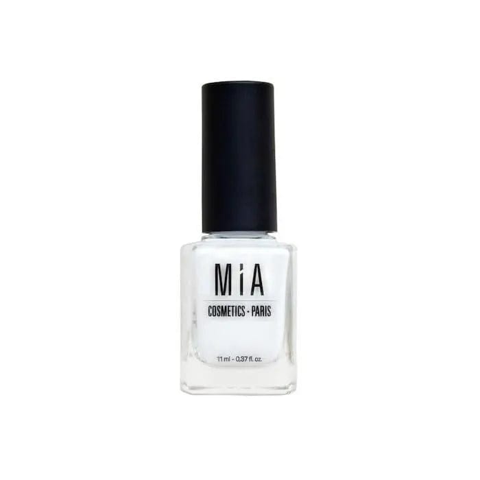 Jag Couture London - New York Mía Cosmetics Frost White nail polish bottle with white cap and clear glass, close-up shot.