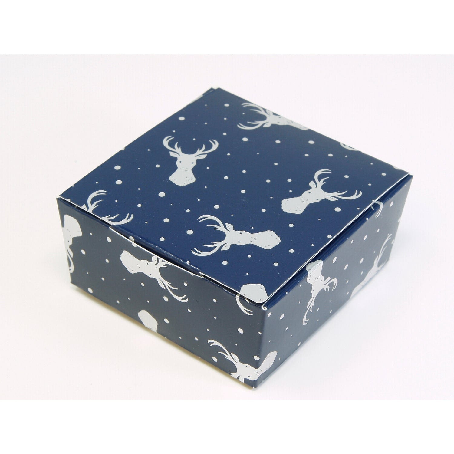 Navy chocolate box with silver stag design by Jag Couture London New York, featuring four assorted chocolates in elegant packaging.
