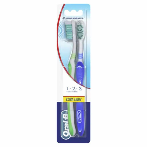 Two Oral-B Shiny Clean Medium toothbrushes from Jag Couture London New York, displayed side by side on a neutral background.
