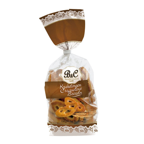 Puff pastry brezels from Jag Couture London New York in a clear bag, showcasing golden, flaky baked pretzel snacks.
