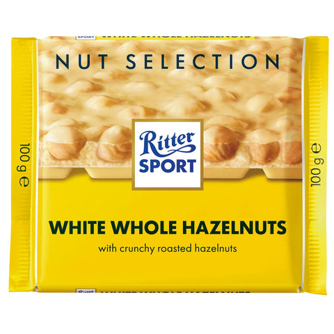 Jag Couture London New York Ritter Sport white chocolate bar with whole hazelnuts, showing the chocolate piece with hazelnuts inside.