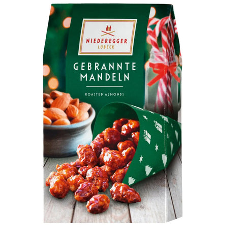 Roasted caramelized almonds in green gift carton by Jag Couture London New York, displayed in an elegant packaging.