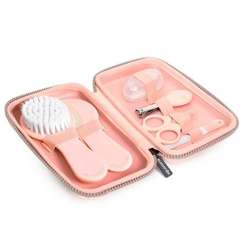 Set of 7 pink Suavinex Hygge baby manicure tools, including clippers and scissors, in a compact case for gentle infant grooming.