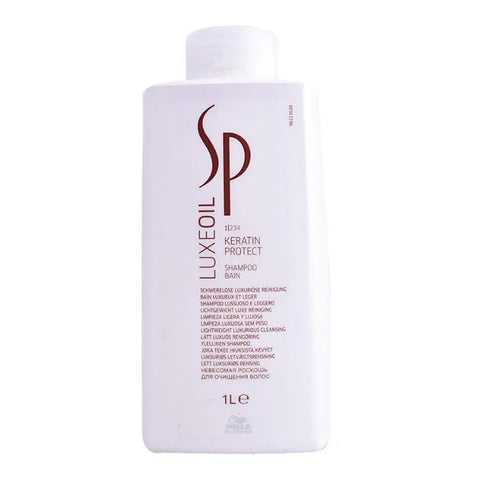 Wella Sp Luxeoil Keratin Protect Shampoo 1000ml in a pump bottle, displayed on a bathroom countertop, brand label visible.