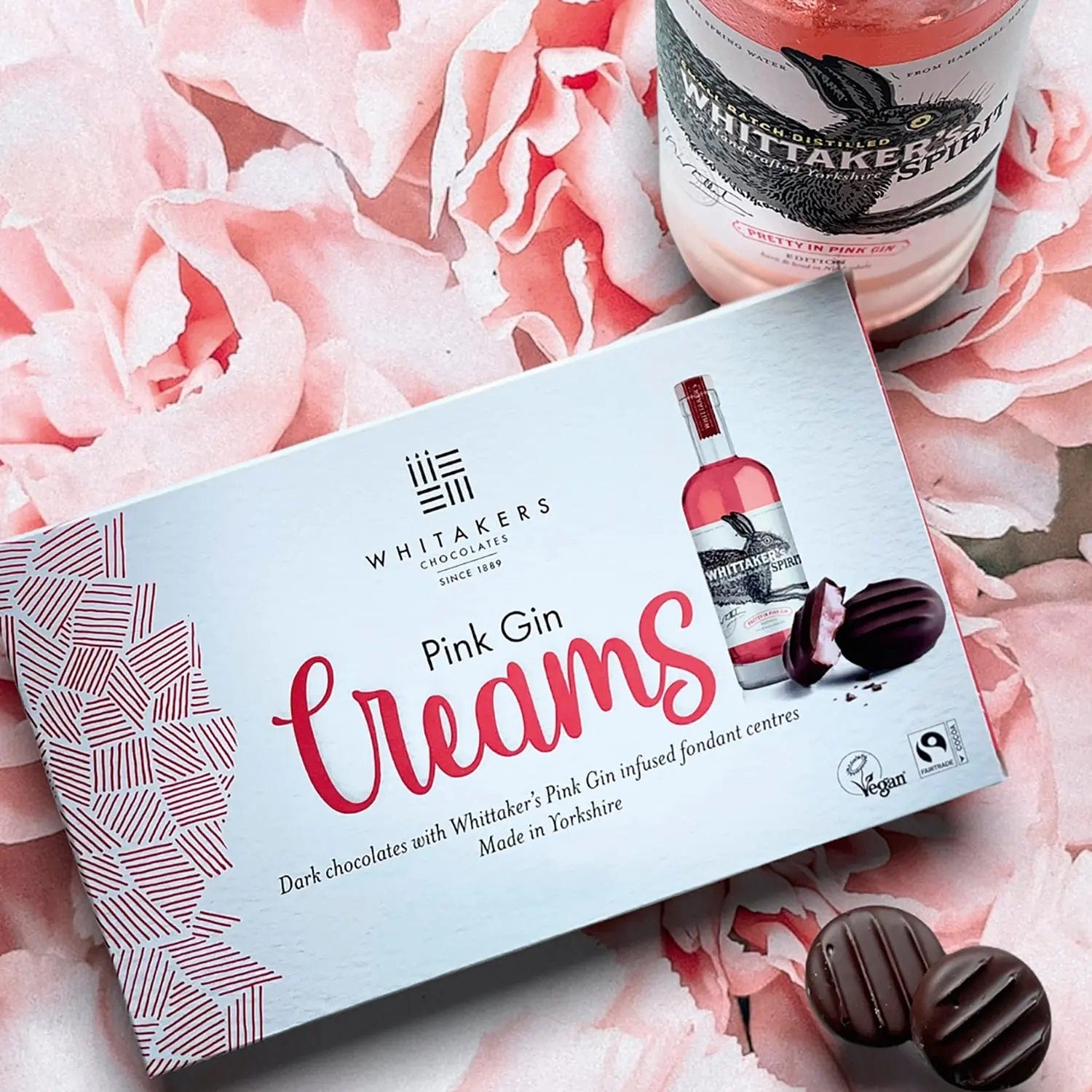 Dark chocolate-covered pink gin fondant creams by Whitakers in a carton, presented by Jag Couture London - New York.