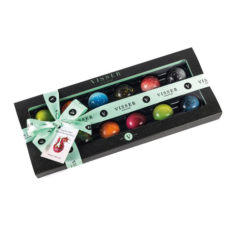 Deluxe gift box of 12 Midi Picasso chocolates by Jag Couture London New York with menu tag, showcasing colorful chocolate art.
