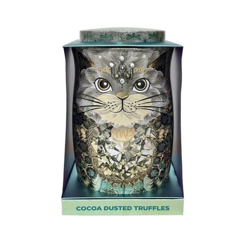 Assorted cocoa dusted truffles in a diamond snow cat tin by Jag Couture London New York, showcasing colorful chocolate treats inside.