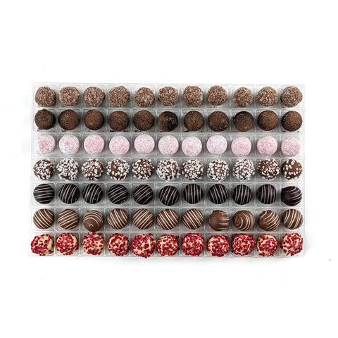 English Truffle Selection by Jag Couture London features milk caramel, dark rum, pink gin, prosecco, cappuccino, orange, and champagne chocolates.
