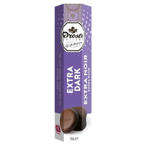 Extra dark chocolate pastilles in a tube by Jag Couture London New York, with shiny dark chocolate coating and elegant packaging.