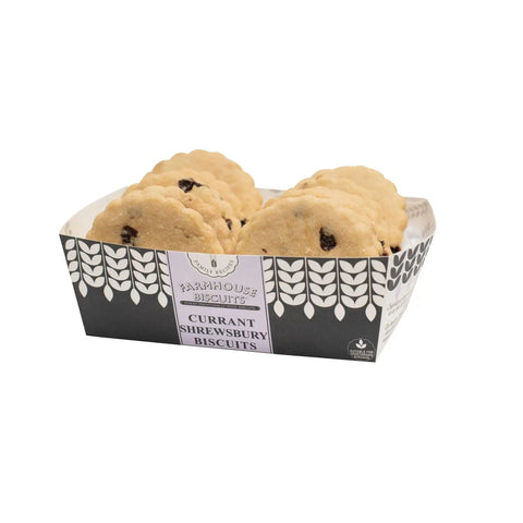 Farmhouse currant Shrewsbury biscuits in a tray by Jag Couture London - New York, showcasing golden-baked biscuits with currants.