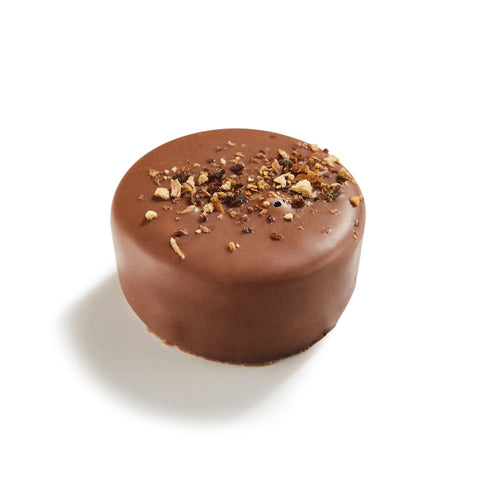 Fedde milk chocolate bar by Jag Couture London with white lemon cheesecake crème, 14.4g, shown with the wrapped chocolate outside the packaging.
