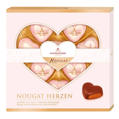 Foiled milk chocolate praline hearts from Jag Couture London in a gift box, featuring shiny foil wrapping and heart-shaped treats.