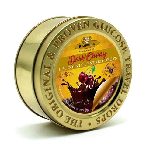 Gold embossed tin of chocolate-centered cherry travel sweets by Jag Couture London - New York, with decorative gold design.