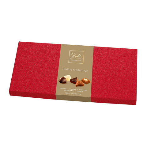 Red flat box of assorted Hamlet Magic Line chocolates by Jag Couture London - New York, showcasing a variety of chocolates inside.