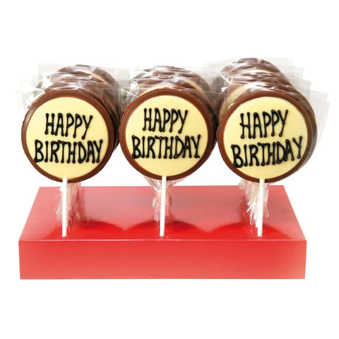 Hand-decorated milk chocolate message lollies with "Happy Birthday" from Jag Couture London New York, featuring detailed chocolate designs.