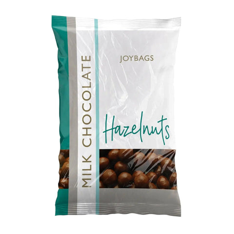 Joybags milk chocolate covered hazelnuts by Jag Couture London - New York, close-up of glossy chocolate-coated hazelnuts.