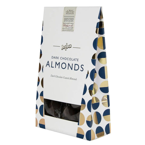 Jag Couture London New York Joybox almonds coated in dark chocolate in a carton, showcasing glossy chocolate-covered almonds.