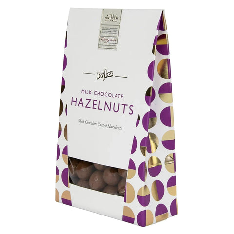 Joybox hazelnuts coated in smooth milk chocolate in a carton by Jag Couture London New York