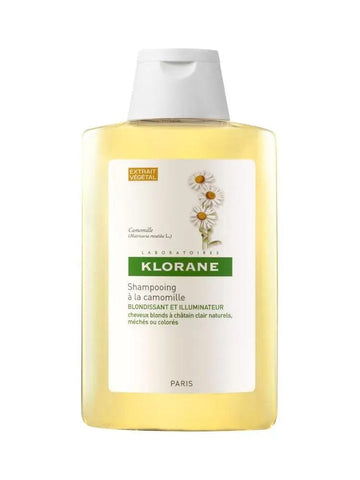 Jag Couture London New York Klorane Camomile Shampoo bottle with a white and yellow label, set against a neutral background.
