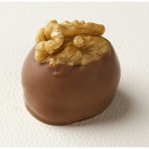 Manon Lait hazelnut caramel mousse tart with croquant base, decorated with a walnut, by Jag Couture London New York.