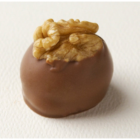 Manon Lait hazelnut caramel mousse on croquant base with walnut decoration, a handcrafted pastry by Jag Couture London New York.
