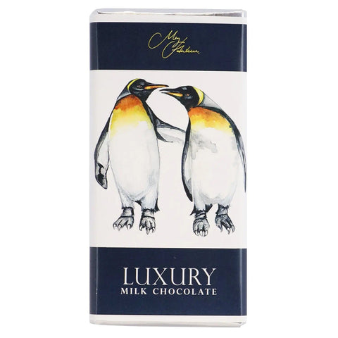 Milk chocolate bar featuring Meg Hawkins penguin design by Jag Couture London New York, with detailed penguin illustration on the wrapper.