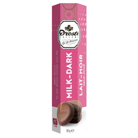 Milk and dark chocolate pastilles in a tube by Jag Couture London New York, displayed in a clear, elegant packaging.