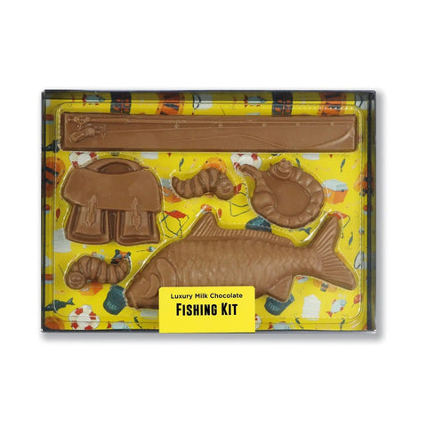 Milk chocolate fishing kit by Jag Couture London in a black gift box with clear lid, showcasing detailed chocolate fishing accessories inside.