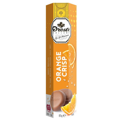 Milk chocolate orange crisp pastilles in a tube by Jag Couture London - New York, showcasing a close-up of the candies inside.