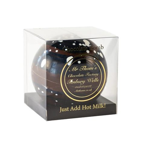 Jag Couture London Mr Thoms dark chocolate bomb inside clear acetate gift box, showcasing a luxurious chocolate treat.