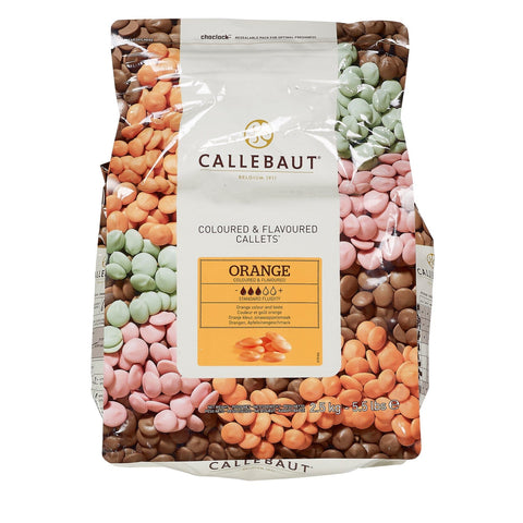 Orange flavoured white chocolate callets from Jag Couture London-New York, shown in a close-up image.