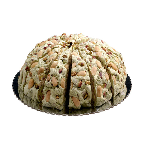 Pistachio-flavored handmade soft nougat cake by Jag Couture London New York with a creamy, nutty texture and decorative pistachio topping.