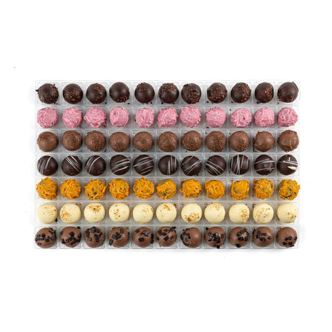 Jag Couture London premium Belgian truffle selection featuring dark truffle, pink champagne, milk caramel, dark rum, orange, lemon, and Irish cream