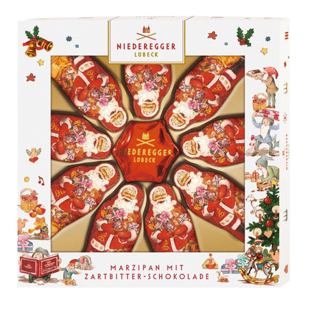 Assorted Santa and star-shaped dark chocolate covered marzipan candies in a gift box by Jag Couture London New York.