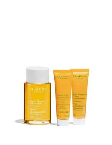 Jag Couture London set featuring Clarins Aroma Aceite Tonic 100ml, gel 30ml, and baume 30ml skincare products.