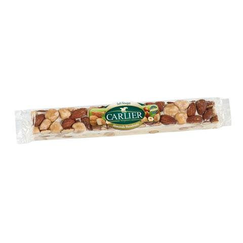 Soft almond and hazelnut wrapped nougat bar by Jag Couture London in a display box, showcasing its creamy texture and nutty ingredients.