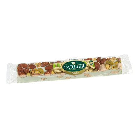 Soft almond and pistachio nougat bar from Jag Couture London in a display box, showcasing its creamy texture and nutty ingredients.