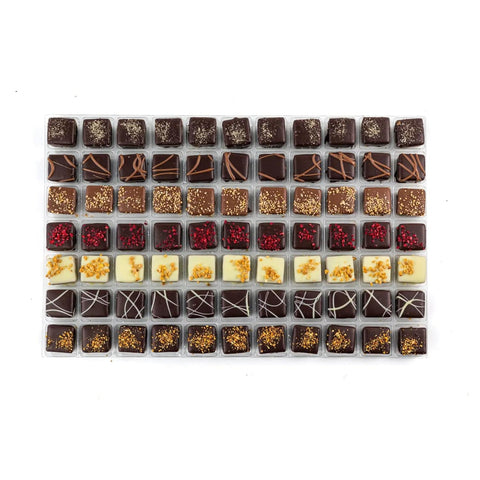Assorted chocolates from Jag Couture London's French Style Collection featuring salted caramel, raspberry, lemon, and bresilienne flavors.