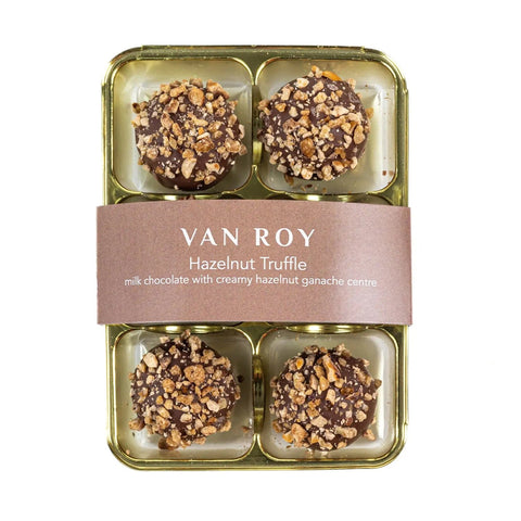 Six Van Roy hazelnut truffles from Jag Couture London in clear cello packaging, showcasing rich, chocolate-coated confections.