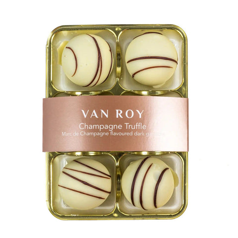 Six white chocolate-covered Marc de Champagne truffles in cello packaging by Van Roy, designed by Jag Couture London New York.