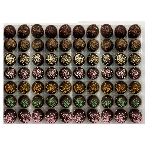 Vegan truffles selection by Jag Couture London featuring coffee, spiced rum, champagne, cherry Bakewell, orange, lime, and raspberry flavors.