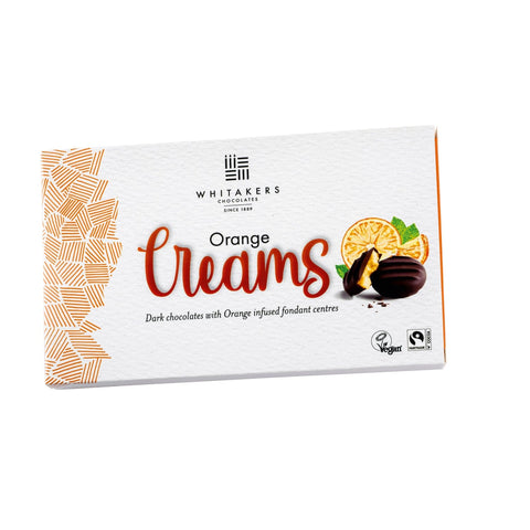 Dark chocolate covered orange fondant creams by Whitakers in a carton, presented by Jag Couture London New York.