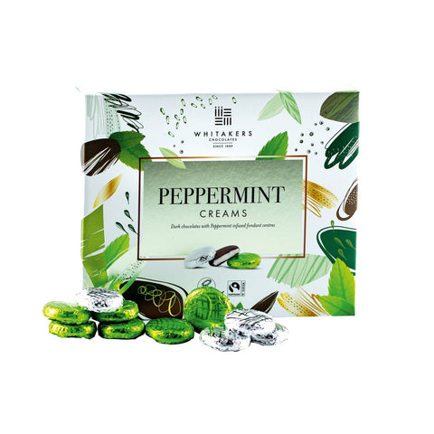 Whitakers foiled dark chocolate peppermint creams in a carton, by Jag Couture London - New York. Handheld view of the chocolates.