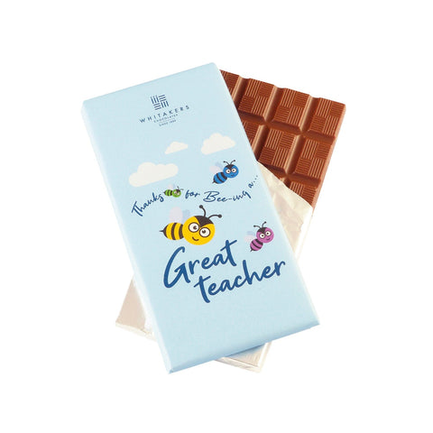 Jag Couture London - New York Whitakers milk chocolate bar with Great Teacher wrapper, showcasing the chocolate and decorative packaging.