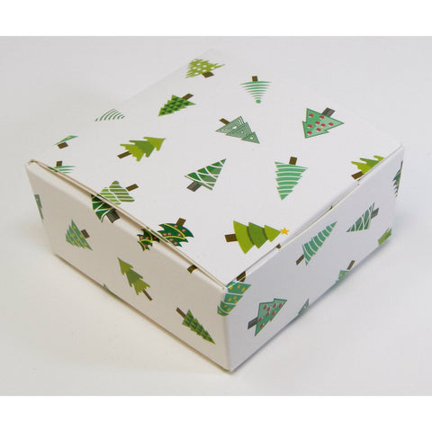 White chocolate box with Christmas tree design from Jag Couture London, featuring four festive chocolates in elegant packaging.