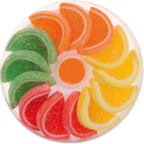 Woogie fruit flavor jellies in a round acetate box by Jag Couture London - New York, showcasing colorful, glossy fruit-shaped candies inside.
