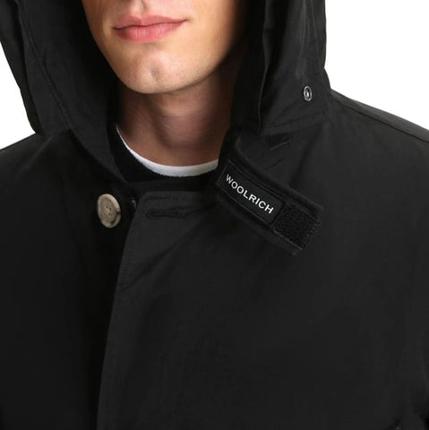 Black Woolrich Arctic Parka on a mannequin, featuring a durable winter coat from Jag Couture London - New York.